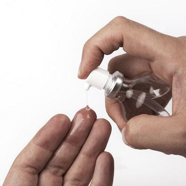a person holding a bottle of liquid in their hand